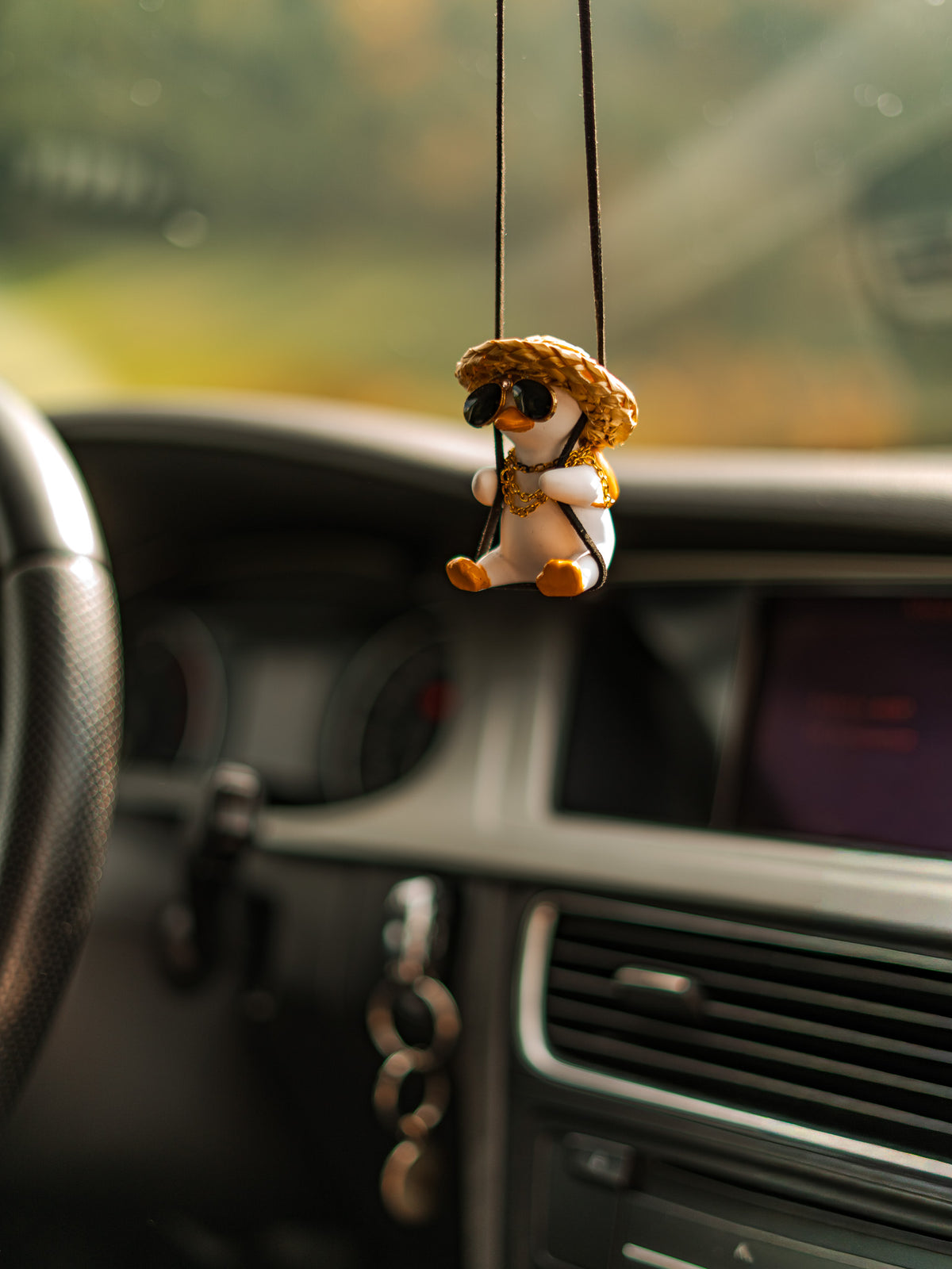 G-Duck hanging ornament in a car interior