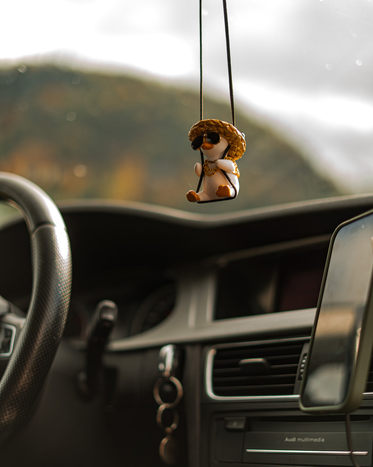 G-Duck hanging ornament in a car interior